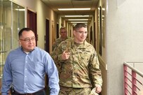 Mr. Juan Alvarez, left, safety officer for the 85th Support Command, walks through the building as soldiers evacuate following a fire alarm being pulled by Alvarez. Alvarez conducted the drill testing the response time of the staff from their work place to the designated rally point upon emergency evacuations.
(Photo by Spc. David Lietz)