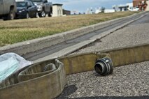 A fire hose sits near a drain during a fuel spill exercise at Minot Air Force Base, N.D., Sept. 8, 2016. The hose was used to help cover the drains and keep the simulated contaminate away and is part of annual training the firefighters receive. (U.S. Air Force photo/Airman 1st Class Jonathan McElderry)