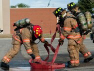 5th Civil Engineer Squadron firefighters work together to contain a simulated fuel spill during a training exercise at Minot Air Force Base, N.D., Sept. 8, 2016. The fuel spill was part of an annual training requirement and the entire process can take from only a few hours up to an entire day to complete, depending on how bad the spill is. (U.S. Air Force photo/Airman 1st Class Jonathan McElderry)