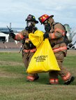 Firefighters with the 5th Civil Engineer Squadron collect simulated contaminated material at Minot Air Force Base, N.D., Sept. 8, 2016. Firefighters were conducting a fuel spill exercise, which is part of a yearly requirement for them. (U.S. Air Force photo/Airman 1st Class Jonathan McElderry)