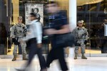 Sgt. Erislav J. Astanov, left, and Spc. Saul Revatta, both part of the New York National Guard’s Joint Task Force Empire Shield, stand guard in a shopping mall and commuter hub at the World Trade Center complex in New York City. The  mission of JTF Empire Shield is to detect and deter terrorism— a mission they’ve been carrying out since Sept. 11, 2001. (Photo by C. Todd Lopez)