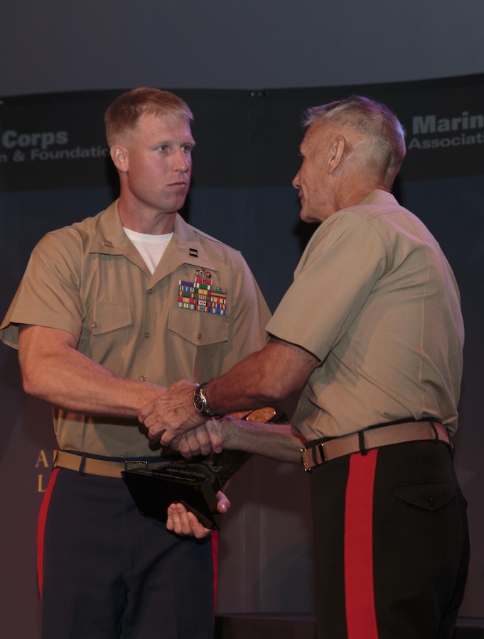 Lt. Gen. Rex C. McMillian, commander of Marine Forces Reserve and Marine Forces North, presents Capt. Michael Thatcher, the company commander for Company K, 3rd Battalion, 25th Marines, with the Colonel Justice Marian “Jumping Joe” Chambers Award during the Marine Corps Reserve Centennial leadership dinner at the National World War II Museum, Aug. 26, 2016. The award is given annually by the Marine Corps Association and Foundation for outstanding leadership by a company grade Reserve officer. (U.S. Marine Corps photo by Sgt. Ian Leones/Released)