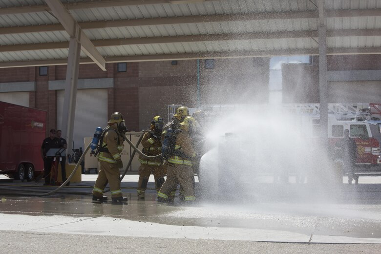 Combat Center firefighters extinguish a simulated propane fire at the fire station aboard the Marine Corps Air Ground Combat Center, Twentynine Palms, Calif., Aug. 26, 2016. (Official Marine Corps photo by Cpl. Thomas Mudd/Released)