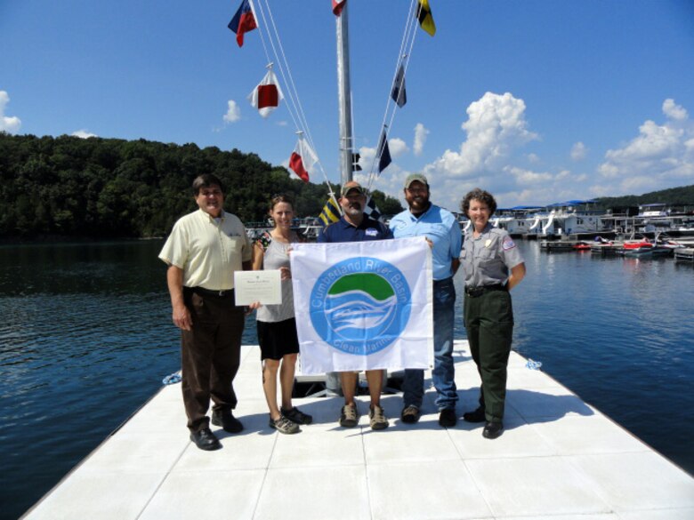 U.S. Army Corps of Engineers Nashville District officials present the Clean Marina flag to April Patterson, owner of Mitchell Creek Marina at the marina on Dale Hollow Lake Aug. 26, 2016.              