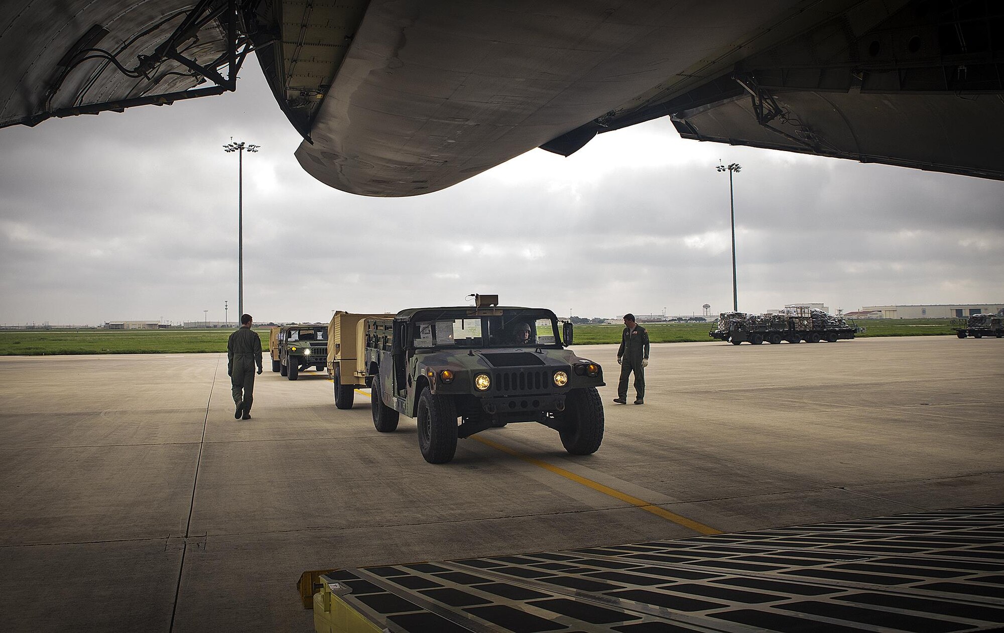 Loadmasters Senior Airman Joshua Green, left, and Tech. Sgt. Jason Badder, 68th Airlift Squadron, perform pre-flight inspections on Humvees prior to loading them on a C-5A Galaxy aircraft Sept. 8, 2016 at Joint Base San Antonio-Lackland, Texas. U.S. Army South’s Headquarters and Headquarters Battalion Soliders from JBSA-Fort Sam-Houston are taking part in a weeklong emergency deployment exercise at Naval Station Guantanamo Bay, Cuba. (U.S. Air Force photo by Benjamin Faske)