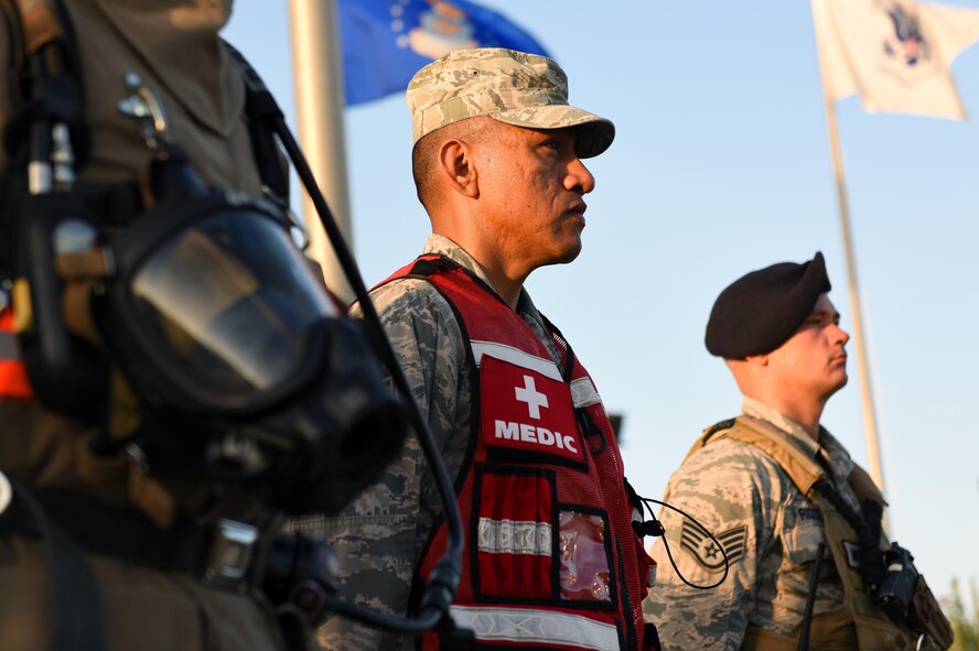 A U.S. Air Force firefighter, medic, and police officer stand at attention during the 9/11 Remembrance Ceremony at the Department of Defense Fallen Firefighter Memorial on Goodfellow Air Force Base, Texas, Sept. 9, 2016. The service members each placed a wreath in representation of the firefighters, medics and policemen who sacrificed their lives responding to the 9/11 attacks. (U.S. Air Force photo by Airman 1st Class Caelynn Ferguson/ Released)