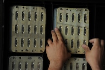 Massachusetts Air National Guard Senior Airman Tim Bennett, a 194th Expeditionary Fighter Squadron munitions systems journeyman, places a container of chaffs into a transport container inside a hardened aircraft shelter on the flightline at Graf Ignatievo, Bulgaria, Sept. 8, 2016. Four of the squadron’s F-15C Eagle fighter aircraft will conduct joint NATO air policing missions with the Bulgarian air force to police the host nation’s sovereign airspace Sept. 9-16, 2016. The squadron forward deployed to Graf Ignatievo from Campia Turzii, Romania, where they serve on a theater security package deployment to Europe as a part of Operation Atlantic Resolve. (U.S. Air Force photo by Staff Sgt. Joe W. McFadden) 