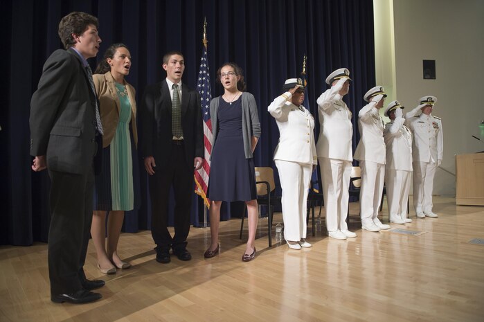 Naval Surface Warfare Center, Carderock Division Commanding Officer Capt. Rich Blank's children sing the national anthem as part of his change of command ceremony in West Bethesda, Md.,  Sept. 8, 2016. Capt. Mark Vandroff assumed the position relieving Capt. Rich Blank as commanding officer. From left: Blank's children, Lt. Christilene Whalen, command chaplain, Naval Support Activity Bethesda; Vandroff; Blank; Rear Adm. Tom Druggan, commander, Naval Surface Warfare Center; Blank; and Rear Adm. Lorin Selby, Chief engineer and deputy commander for Ship Design, Integration and Naval Engineering, Naval Seas Systems Command. (U.S. Navy photo by Ryan Hanyok/Released)