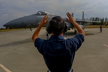 California Air National Guard Staff Sgt. Zechery Blackburn, a 194th Expeditionary Fighter Squadron crew chief, signals to the pilot of an F-15C Eagle fighter aircraft on the flightline at Graf Ignatievo, Bulgaria, Sept. 8, 2016. Four of the squadron’s F-15Cs will conduct joint NATO air policing missions with the Bulgarian air force to police the host nation’s sovereign airspace Sept. 9-16, 2016. The squadron forward deployed to Graf Ignatievo from Campia Turzii, Romania, where they serve on a theater security package deployment to Europe as a part of Operation Atlantic Resolve. (U.S. Air Force photo by Staff Sgt. Joe W. McFadden) 