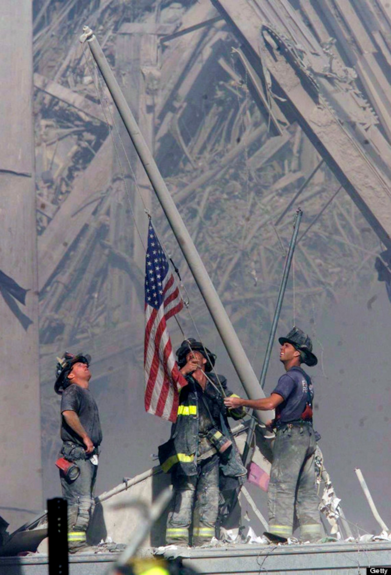 Firefighters raise an American flag at the site of the Twin Towers. (Courtesy photo)