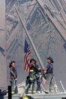 Firefighters raise an American flag at the site of the Twin Towers. (Courtesy photo)