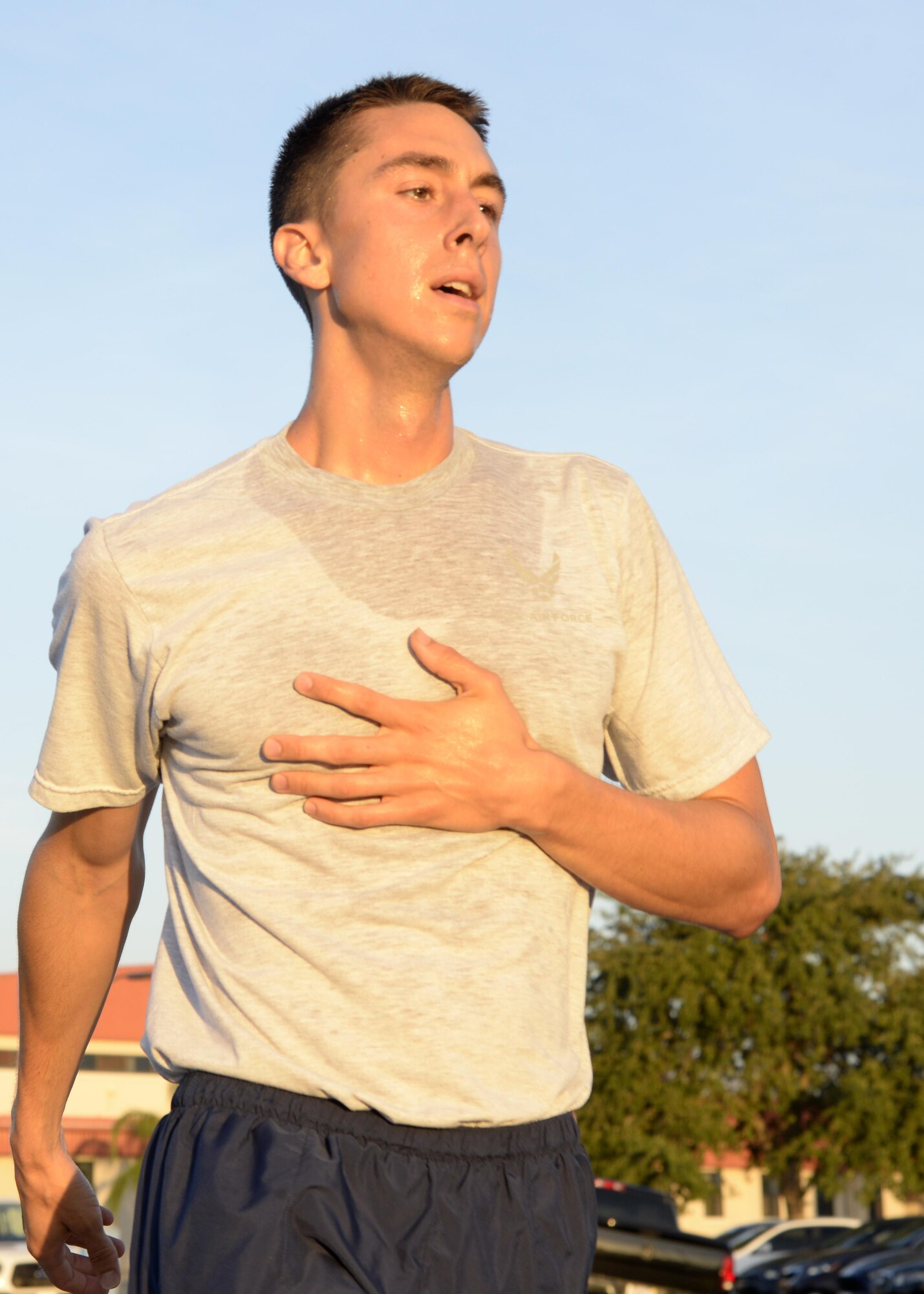 Airman 1st Class Matthew Larkins, a base radio technician assigned to the 6th Communications Squadron, crosses the finish line during a 9/11 Memorial 5K at MacDill Air Force Base, Fla., Sept. 9, 2016. Larkins completed the 5K in 18 minutes and 26 seconds, the fastest time of the 180 participants. (U.S. Air Force photo by Tech. Sgt. Krystie Martinez)