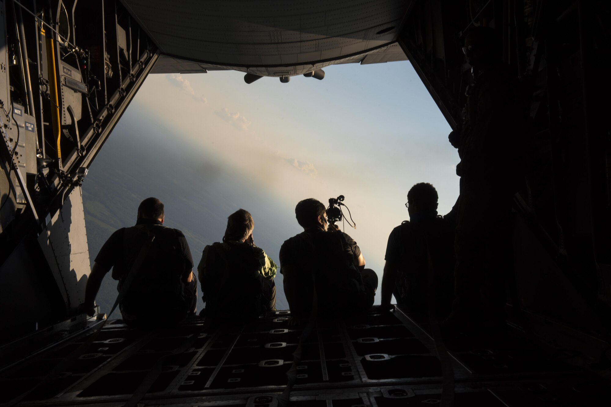 Media members from North West Florida Daily News and Air Force Times sit on the ramp of an MC-130H Combat Talon II aircraft during a media day at Hurlburt Field, Fla., Sept. 7, 2016. During the media day, the news professionals were able to take photos and videos of a tiltrotor air-to-air refueling mission. (U.S. Air Force photo by Staff Sgt. Christopher Callaway) 