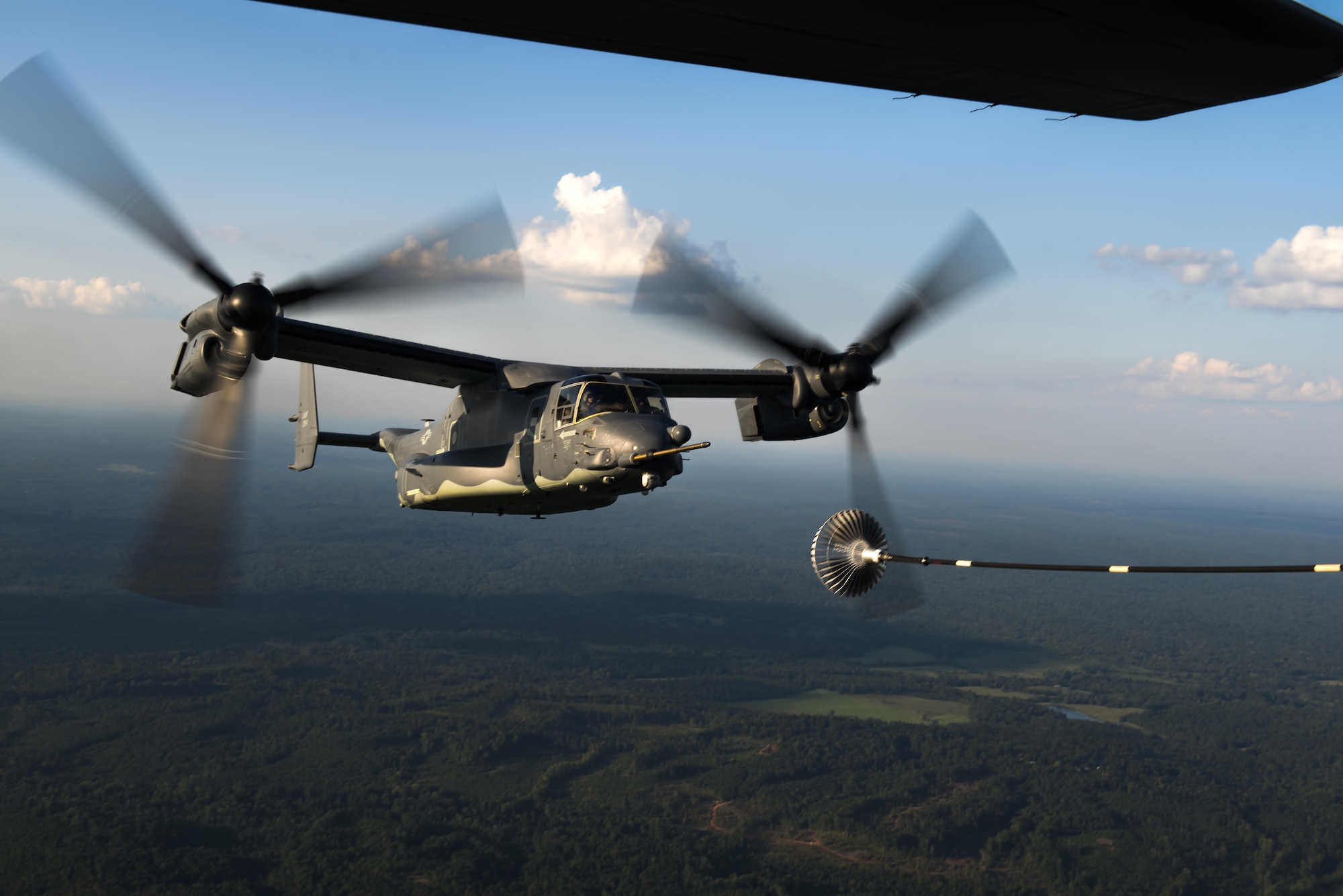 A CV-22 Osprey tiltrotor aircraft approaches an MC-130H Combat Talon II air-refueling receptacle during a training mission at Hurlburt Field, Fla., Sept. 7, 2016. The Osprey is a tiltrotor aircraft that combines the vertical takeoff, hover and vertical landing qualities of a helicopter with the long-range, fuel efficiency and speed characteristics of a turboprop aircraft. (U.S. Air Force photo by Staff Sgt. Christopher Callaway) 