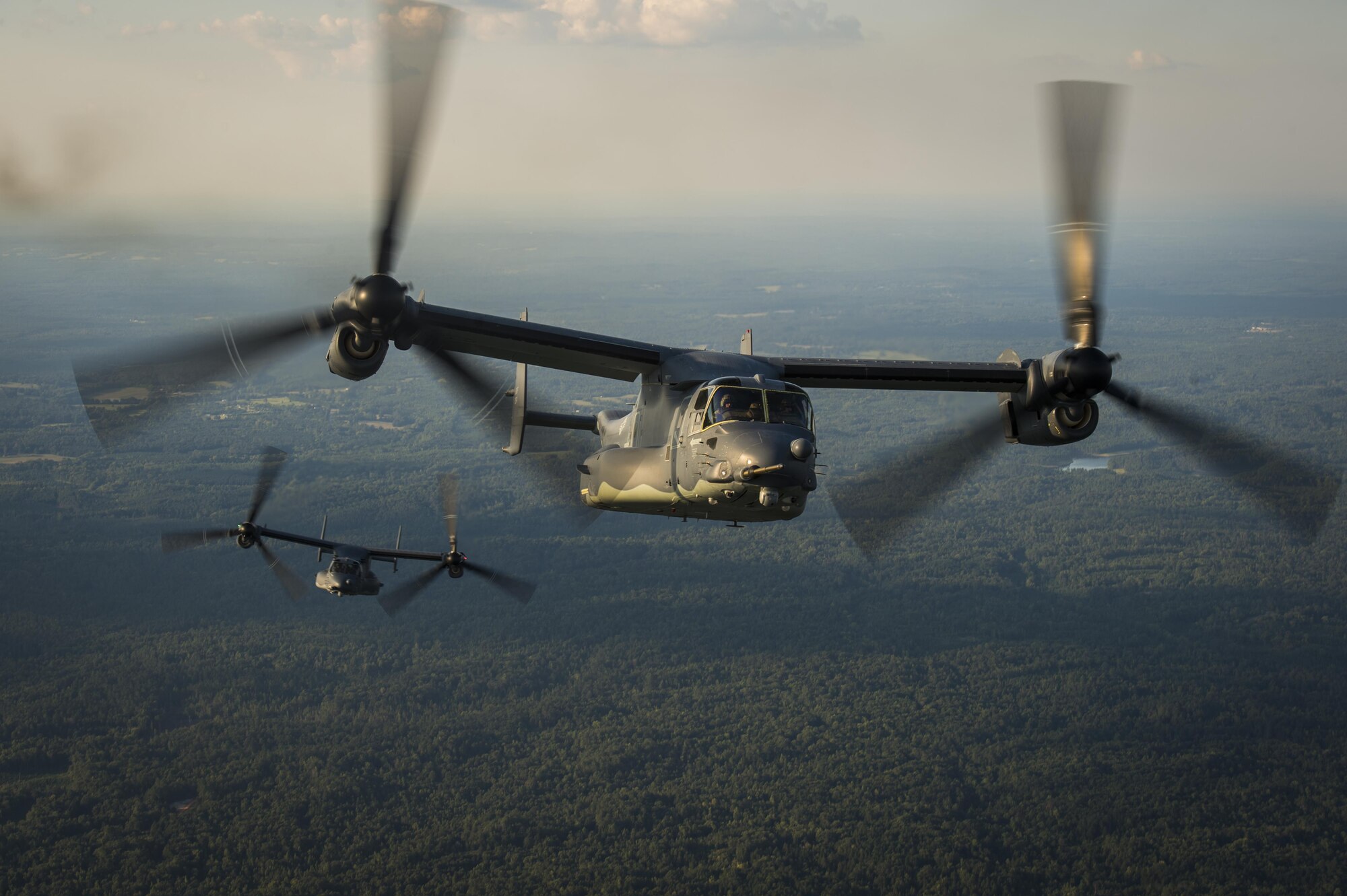 Two CV-22 Osprey tiltrotor aircraft approach an MC-130H Combat Talon II air-refueling receptacle during a training mission at Hurlburt Field, Fla., Sept. 7, 2016. The Osprey is a tiltrotor aircraft that combines the vertical takeoff, hover and vertical landing qualities of a helicopter with the long-range, fuel efficiency and speed characteristics of a turboprop aircraft. (U.S. Air Force photo by Staff Sgt. Christopher Callaway) 