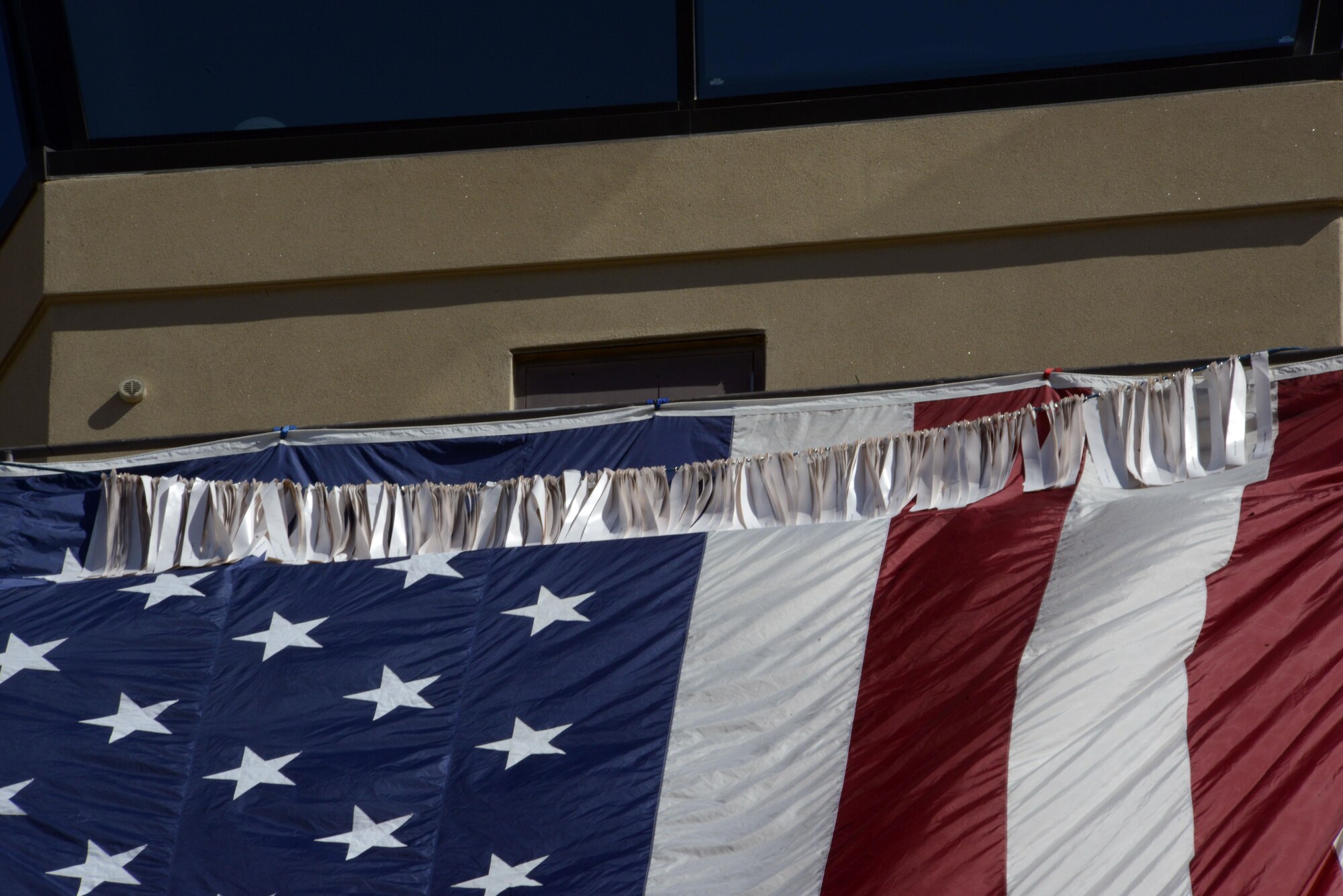 A line bearing the names of the fallen first responders of Sept.11, 2001, lies across the American Flag during the 9/11 Memorial Ceremony Sept. 9, 2016 at Luke Air Force Base, Ariz. (U.S. Air Force photo by Senior Airman Devante Williams)