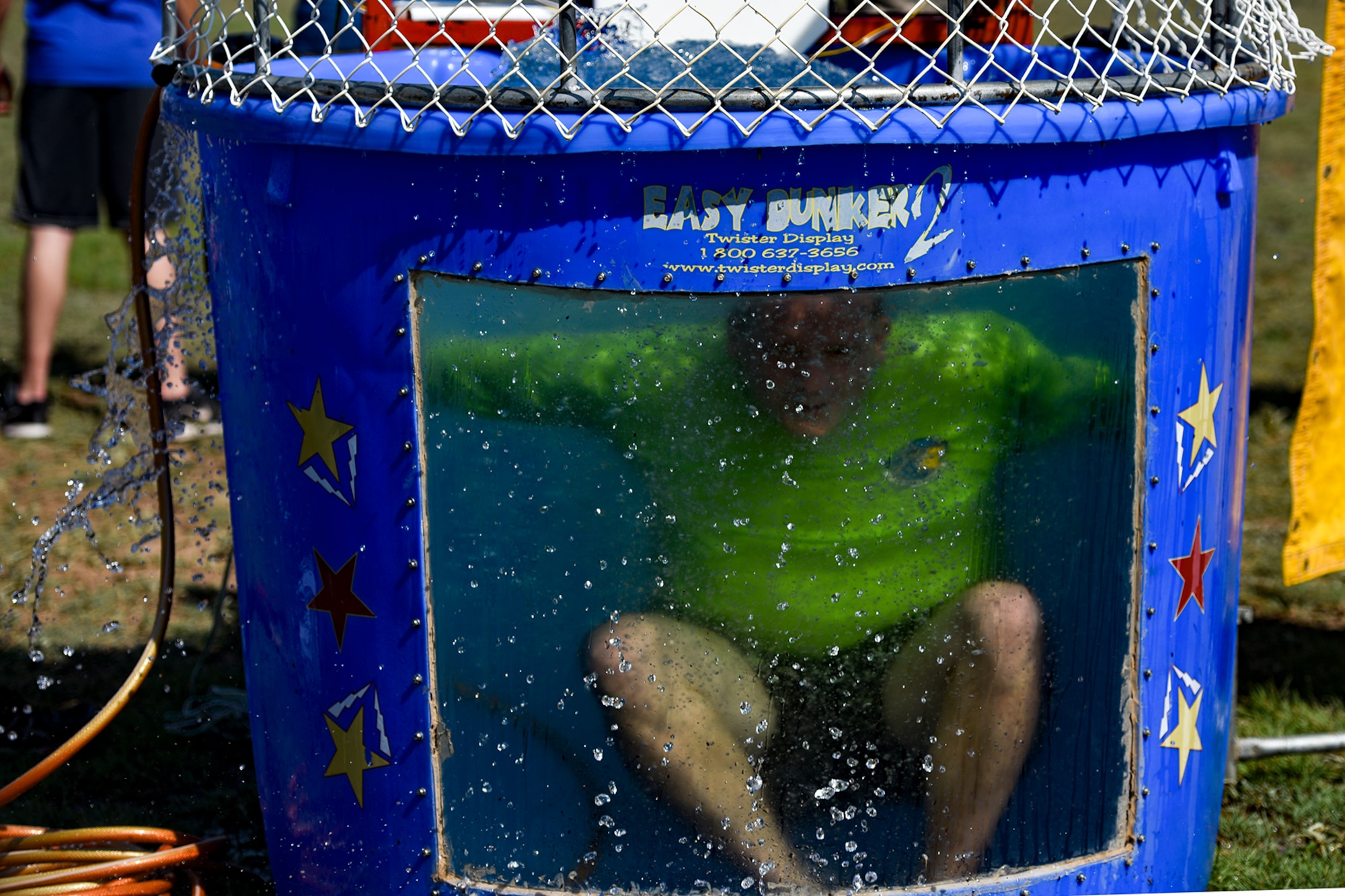 U.S. Air Force Maj. John Travieso, 17th Contracting Squadron commander, drops into a dunk tank during the Combined Federal Campaign kickoff tailgate party at the parade field on Goodfellow Air Force Base, Texas, Sept. 8, 2016. Goodfellow members donated money to take a chance at dunking their commanders to raise money for the CFC. (U.S. Air Force photo by Senior Airman Devin Boyer/Released)