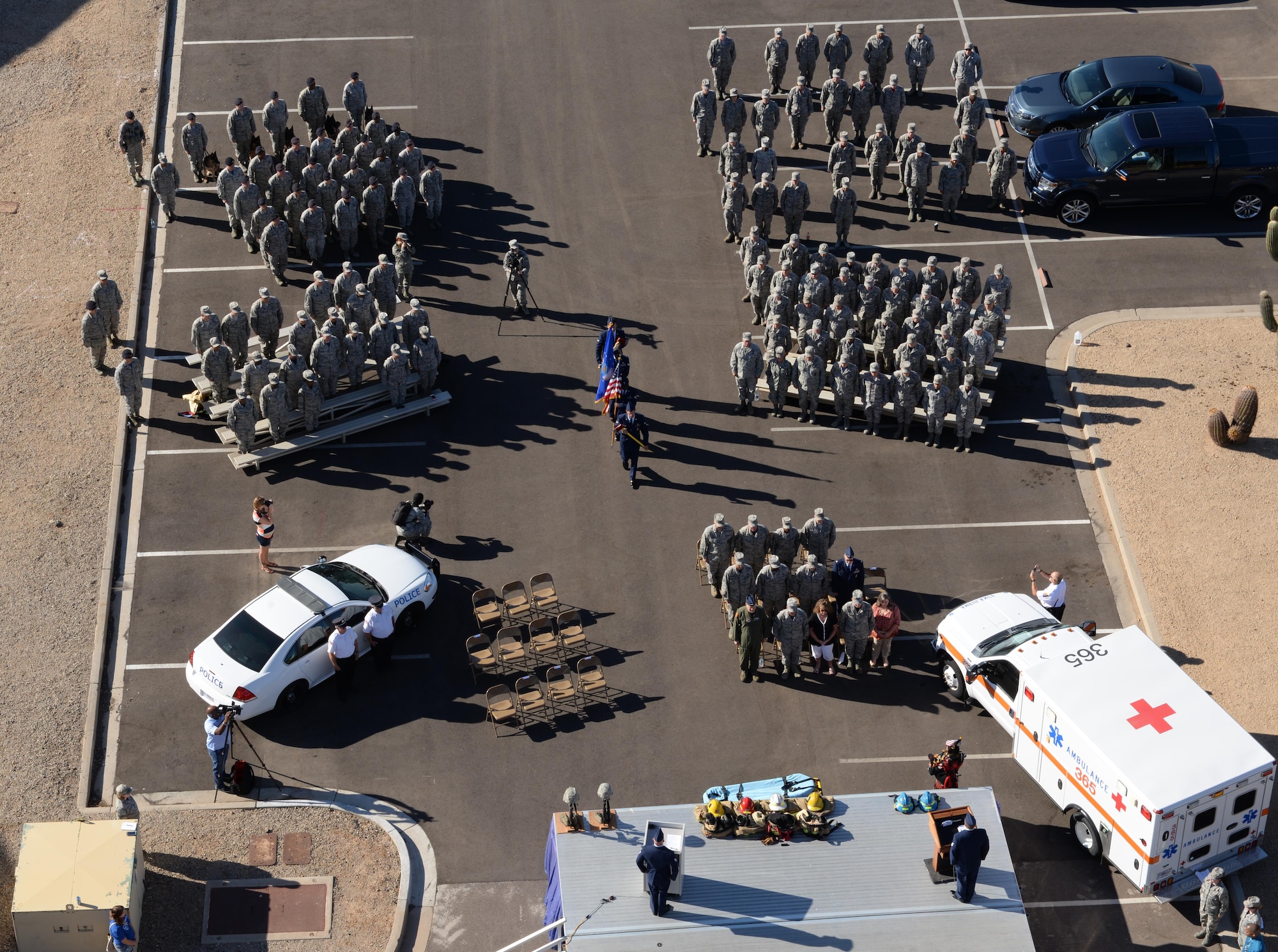 A ceremony to honor the fallen firefighters who responded to the terrorist attacks on Sept. 11, 2001, takes place below the air traffic control tower Sept. 9, 2016, at Luke Air Force Base, Ariz. Following the ceremony, Airmen and firefighters from across the base ran up and down the tower's stairwell to bring streamers bearing the names of the fallen to the top. (U.S. Air Force photo by Airman 1st Class Ridge Shan)