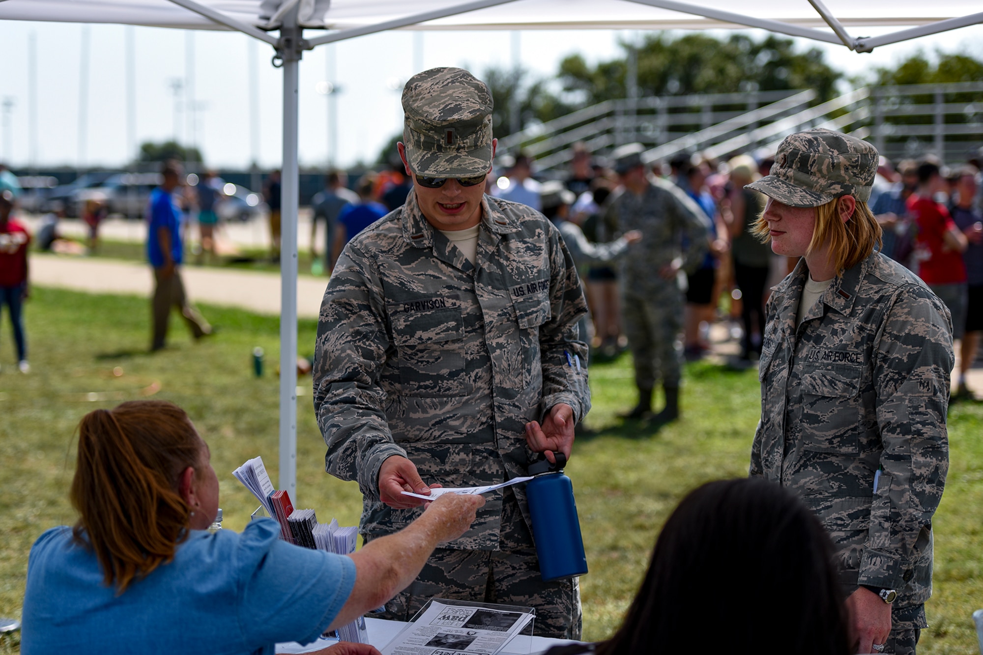 U.S. Air Force officers from the 17th Training Wing visit a non-profit organization’s booth during the Combined Federal Campaign kickoff tailgate party at the parade field on Goodfellow Air Force Base, Texas, Sept. 8, 2016. Local non-profit organizations set up booths to give Goodfellow members a chance to donate to their cause as part of the CFC. (U.S. Air Force photo by Senior Airman Devin Boyer/Released)