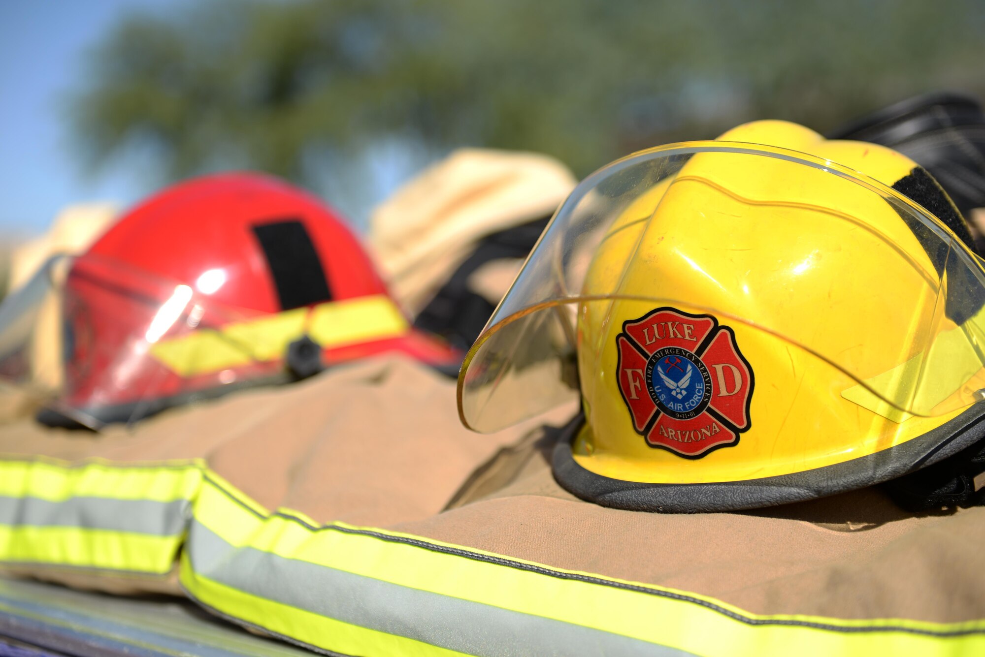 A ceremony to honor the fallen firefighters who responded to the terrorist attacks on Sept. 11, 2001, takes place below the air traffic control tower Sept. 9, 2016, at Luke Air Force Base, Ariz. Following the ceremony, Airmen and firefighters from across the base ran up and down the tower's stairwell to bring streamers bearing the names of the fallen to the top. (U.S. Air Force photo by Airman 1st Class Ridge Shan)