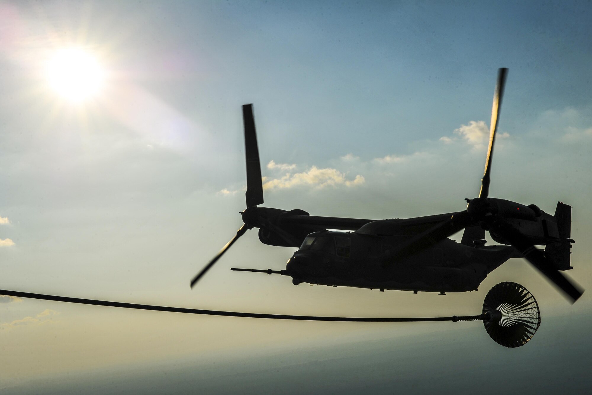 A CV-22 Osprey tiltrotor aircraft flies away from an MC-130H Combat Talon II following a tiltrotor air-to-air refueling training mission at Hurlburt Field, Fla., Sept. 7, 2016. The Osprey combines the vertical takeoff, hover and vertical landing qualities of a helicopter with the long-range, fuel efficiency and speed characteristics of a turboprop aircraft. (U.S. Air Force photo by Airman 1st Class Joseph Pick)