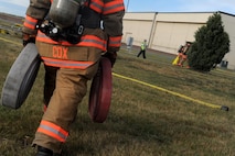 Airman 1st Class Benjamin Cox, 5th Civil Engineer Squadron firefighter, carries hoses at Minot Air Force Base, N.D., Sept. 8, 2016. Cox carried the hoses to help contain a simulated fuel spill which was part training that is conducted annually. (U.S. Air Force photo by Staff Sgt. Chad Trujillo)

