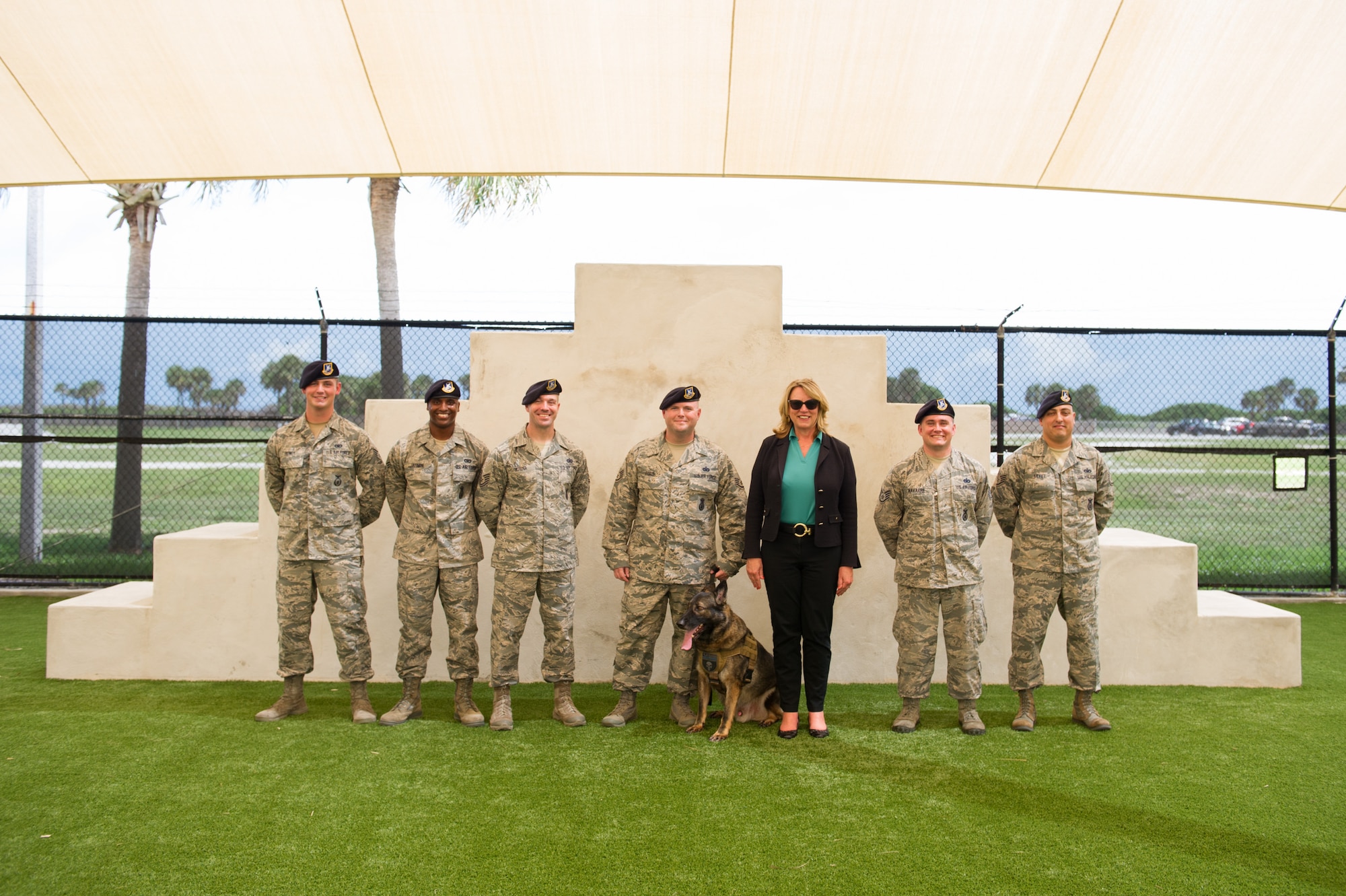 The Honorable Deborah Lee James Secretary of the Air Force poses for a photo with members of the 45th Security Force Squadron after a K-9 demonstration Sept. 9, 2016, at Patrick Air Force Base, Fla. Her two-day stay included an all call, meeting with members of Patrick-Cape and its mission partners, and a visit to the Atlas Spacecraft Operations Center where she witnessed her first launch at the Eastern Range. (U.S. Air Force photo/Matthew Jurgens)