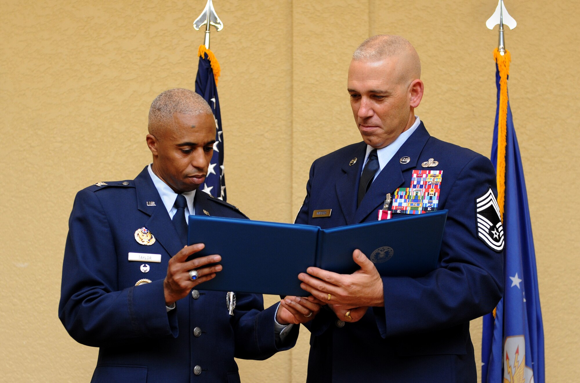 Col. Fred Taylor, Jr., Joint Space Operations Center deputy director and National Reconnaissance Office Liaison, Vandenberg Air Force Base, Calif., presents a certificate of appreciation to Chief Master Sgt. Robert Winters, 81st Training Group superintendent, during his retirement ceremony at the Bay Breeze Event Center Sept. 8, 2016, on Keesler AFB, Miss. Winters retired with more than 29 years of military service and served multiple assignments in California, Louisiana, Georgia, Colorado, Korea and the United Kingdom. He also worked as an electronic warfare officer in support of more than 700 soldiers in multiple locations throughout Iraq. (U.S. Air Force photo by Kemberly Groue/Released)