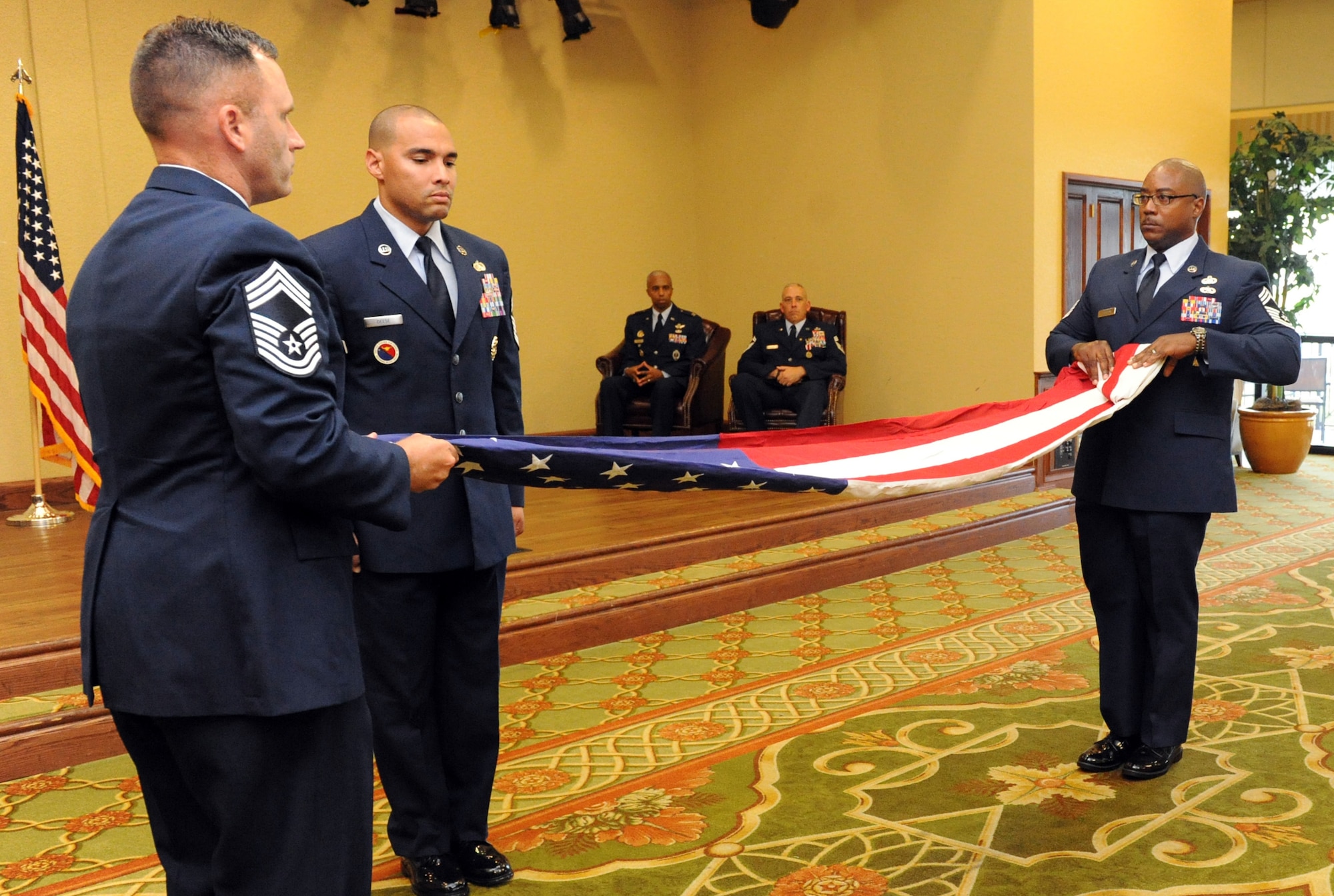 Members of the Keesler Chief’s Group conduct a flag folding ceremony during the retirement ceremony for Chief Master Sgt. Robert Winters, 81st Training Group superintendent, at the Bay Breeze Event Center Sept. 8, 2016, on Keesler Air Force Base, Miss. Winters retired with more than 29 years of military service and served multiple assignments in California, Louisiana, Georgia, Colorado, Korea and the United Kingdom. He also worked as an electronic warfare officer in support of more than 700 soldiers in multiple locations throughout Iraq. (U.S. Air Force photo by Kemberly Groue/Released)