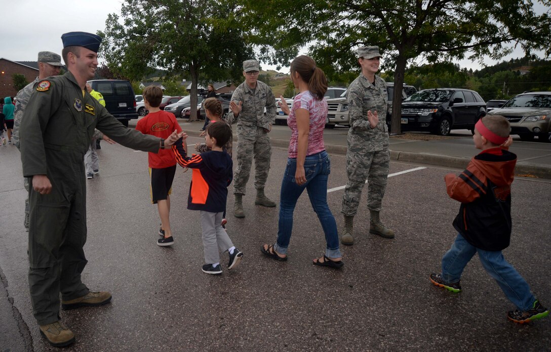 Airmen from the 28th Bomb Wing meet and greet students and faculty members from Southwest Middle School and Corral Drive Elementary School during the 2nd Annual Patriot Day parade at Southwest Middle School in Rapid City, S.D., Sept. 9, 2016. The parade was held to observe Patriot Day, a day honoring and remembering the victims of the attacks on Sept. 11, 2001. (U.S. Air Force photo by Airman 1st Class Denise M. Jenson)