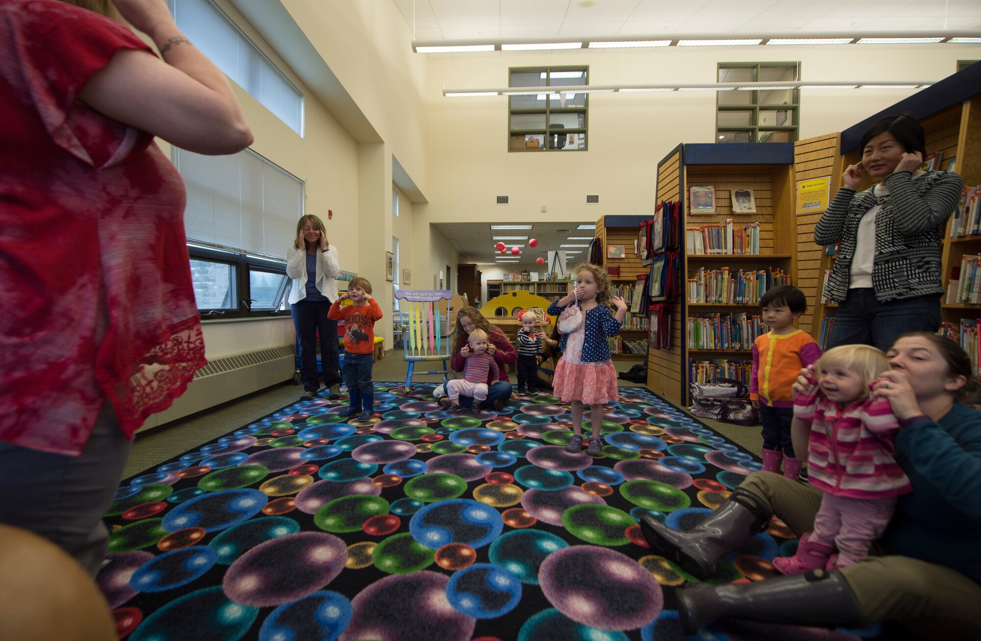 Parents and children dance to Head, Shoulder, Knees and Toes during Preschool Story Time at the Joint Base Elmendorf-Richardson, Alaska, Sept. 8, 2016. 