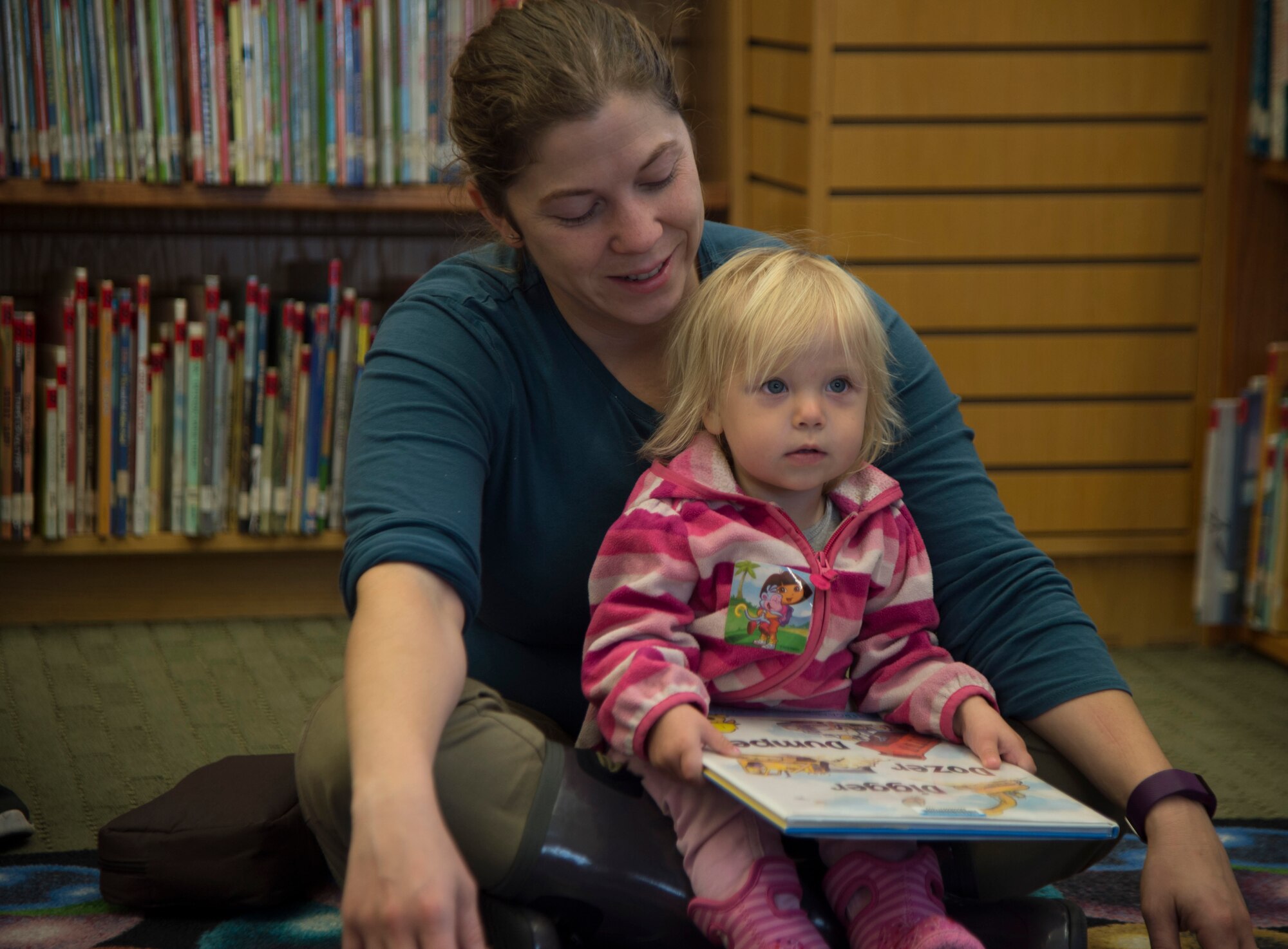 Anastasia, 1, listens to the library technician during Preschool Story Time at the Joint Base Elmendorf-Richardson Consolidated Library, Alaska, Sept. 8, 2016. Preschool Story Time is every Thursday from 10 to 11 a.m. Anastasia is the daughter of majors Christopher and Jessica Denzer from the 611th Air and Space Operations Center and 166th Airlift Wing, Delaware Air National Guard, respectively.