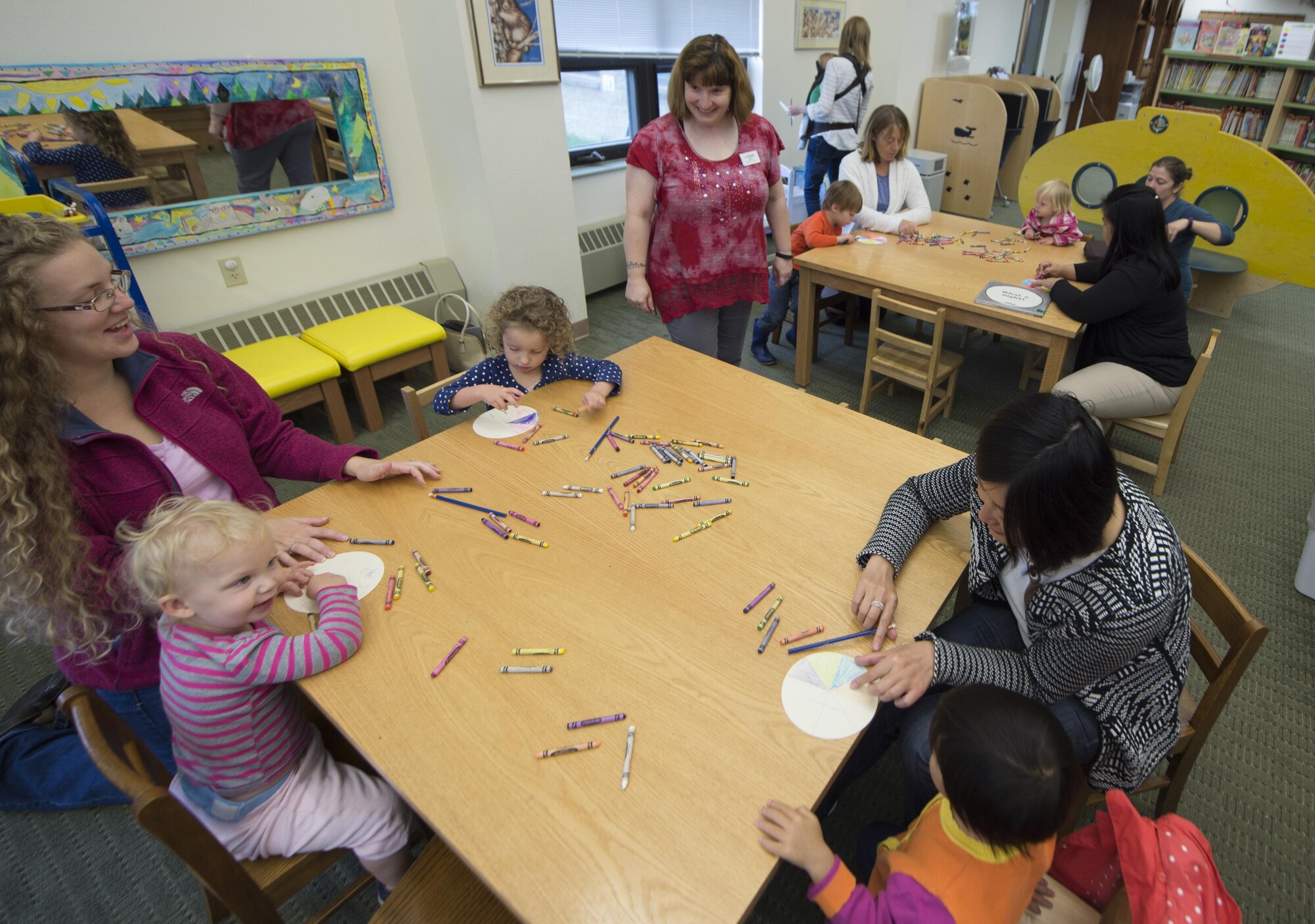 Library technician Teresa Couch, center, watches children making crafts after listening to a story during Preschool Story Time at Joint Base Elmendorf-Richardson, Alaska, Sept. 8, 2016. The Preschool Story Time is every Thursday from 10 to 11 a.m.