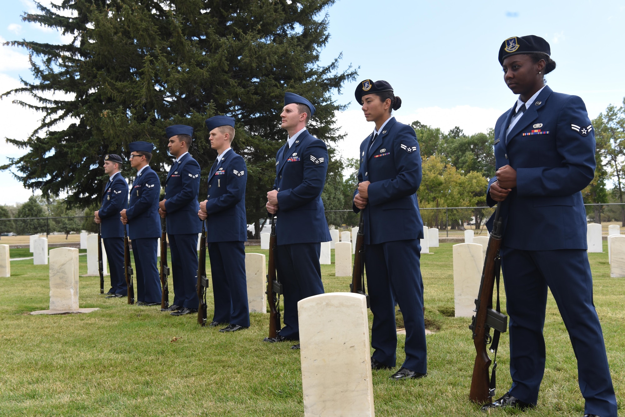 Honor guard graduates in a firing party stand in formation during a mock funeral on F.E. Warren Air Force Base, Wyo. Sept. 9. Graduates showcased their precision movements during the ceremony. (U.S. Air Force photo by Airman 1st Class Breanna Carter) 