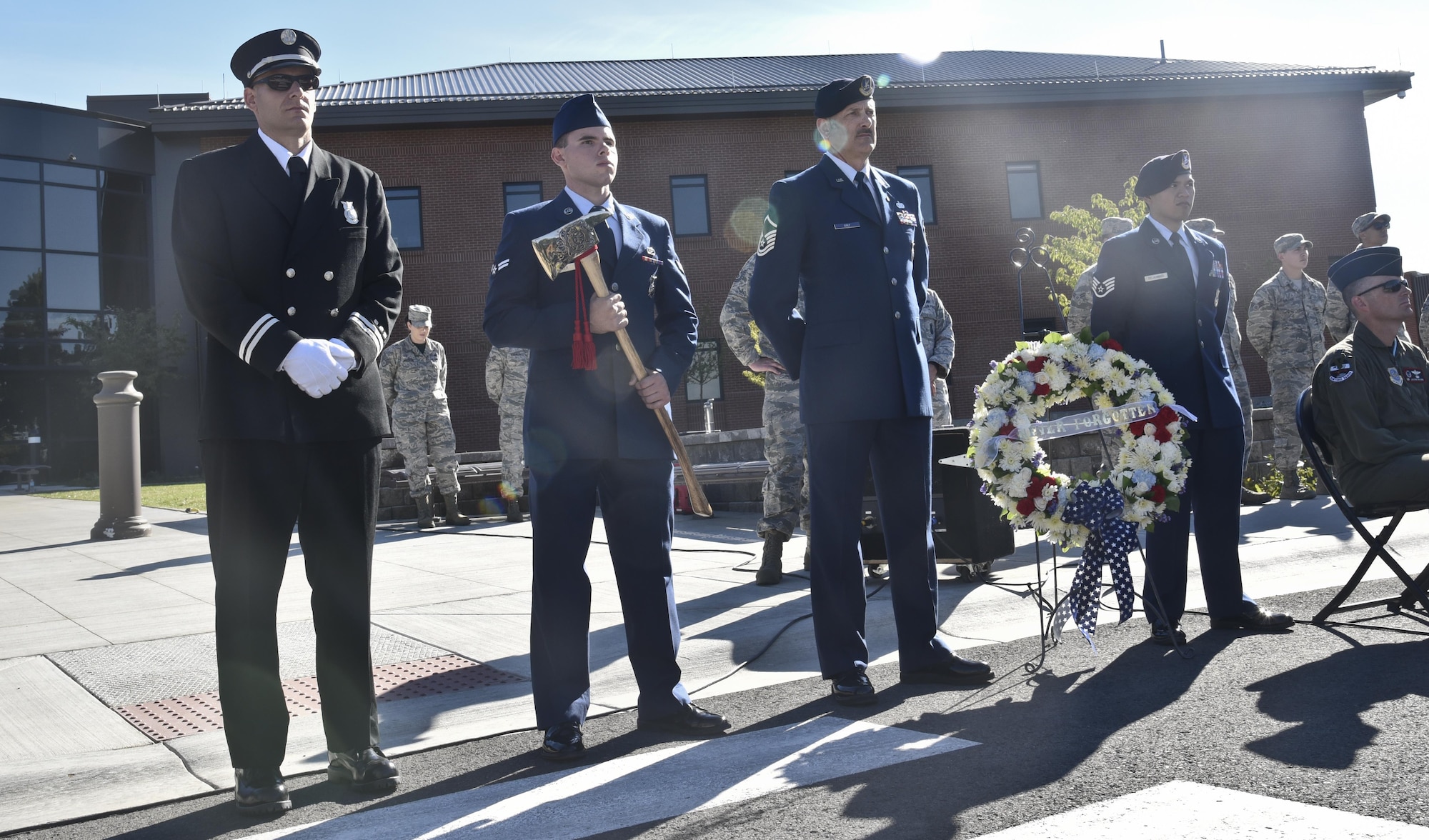 Members from Fairchild's 92nd Civil Engineer Squadron Fire Department and 92nd Security Forces Squadron stand during the Patriot's Day retreat ceremony Sept. 9, 2016, at Fairchild Air Force Base, Wash. The ceremony was held in remembrance of those who lost their lives in the Sept. 11, 2001 terrorist attacks. (U.S. Air Force photo/Airman 1st Class Taylor Shelton)