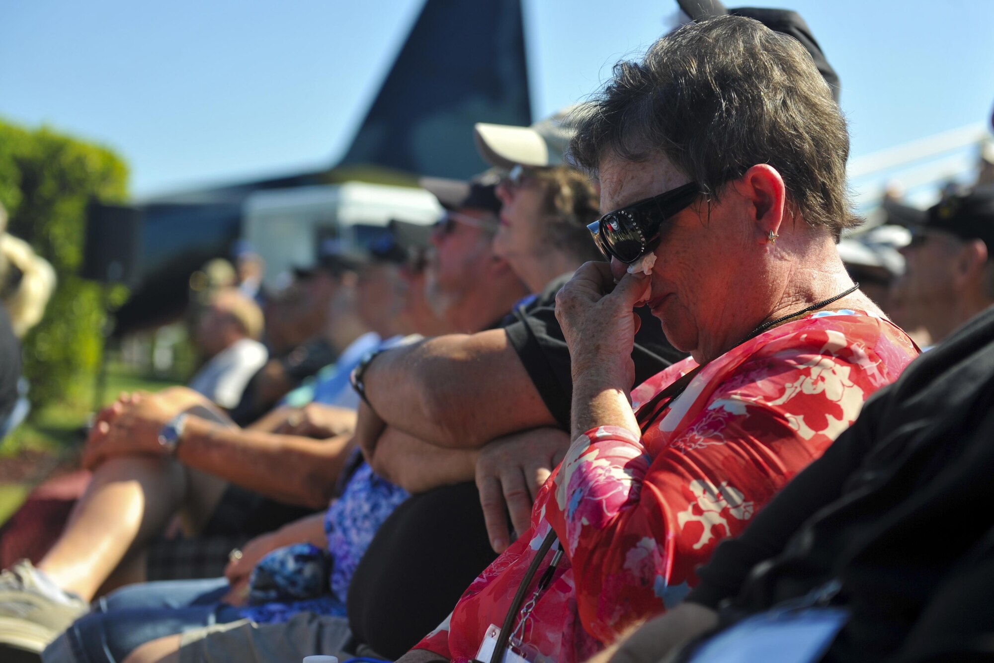 A family member of the AC-47 Spooky Gunship Brotherhood wipes her tears during a plaque dedication ceremony at the Hurlburt Field Air Park, Fla., Sept. 9, 2016. The Spooky brotherhood purchased the memorial plaque with the names of fallen AC-47 crewmembers, who served in Southeast Asia. (U.S. Air Force photo by Airman Dennis Spain)