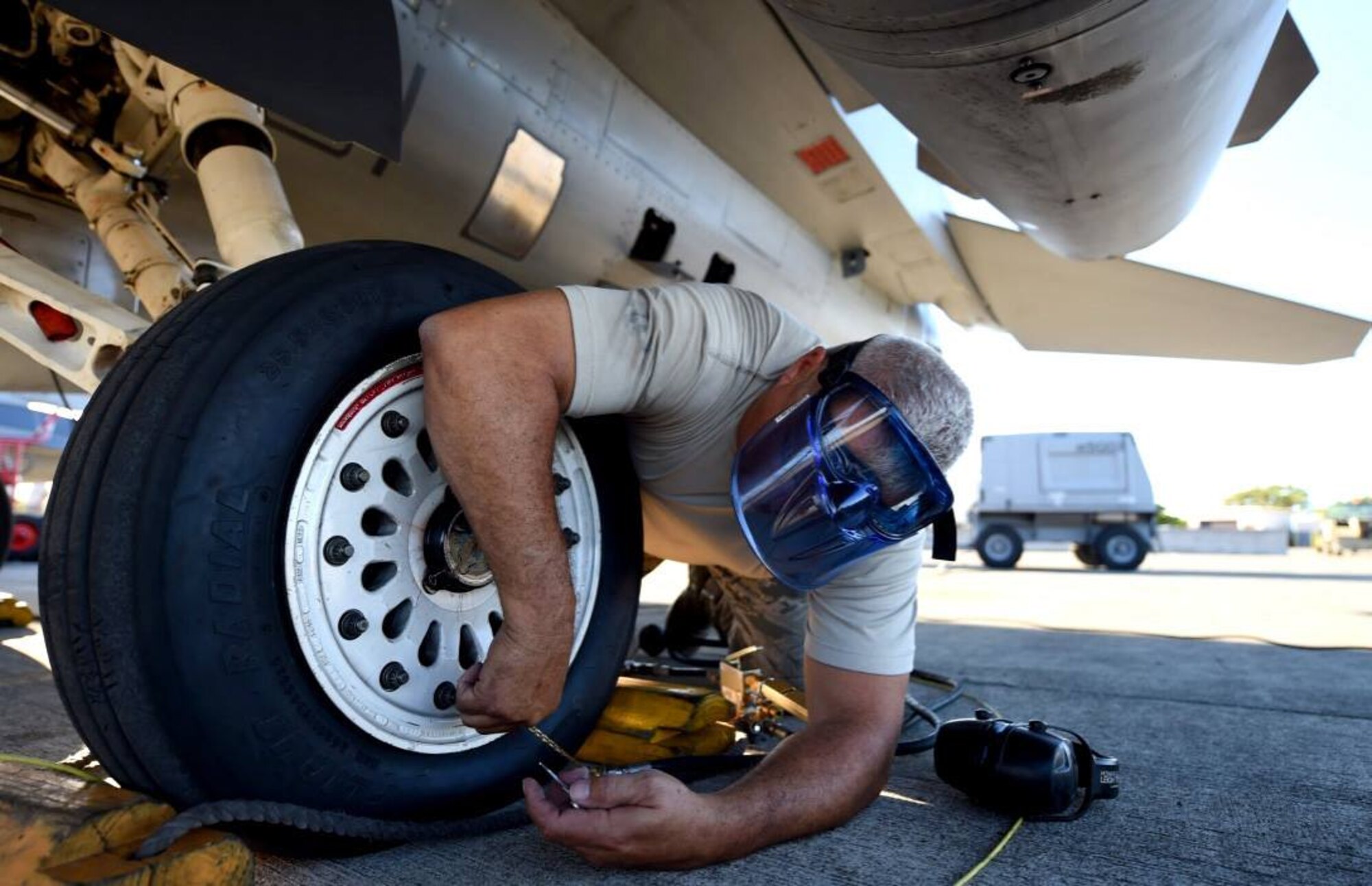 Master Sgt. Dwayne Gore, a crew chief with the 149th Fighter Wing, Texas Air National Guard, headquartered at Joint Base San Antonio-Lackland, Texas, services the tire of an F-16 Fighting Falcon at Joint Base Pearl Harbor Hickam, Hawaii, Aug. 18, 2016. Gore participated in Sentry Aloha 2016, a large-scale fighter exercise hosted by the Hawaii Air National Guard. (U.S. Air National Guard photo by Tech. Sgt. Rebekkah Jandron)