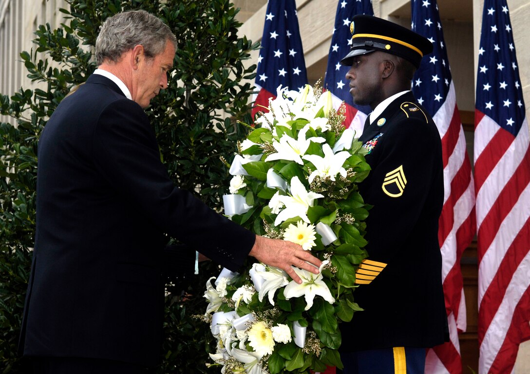 President George W. Bush lays a wreath at the crash site of American Airlines Flight 77 at the Pentagon on the fifth anniversary of the 9/11 terrorist attacks, Sept. 11, 2006. DoD photo by Air Force Staff Sgt. D. Myles Cullen    