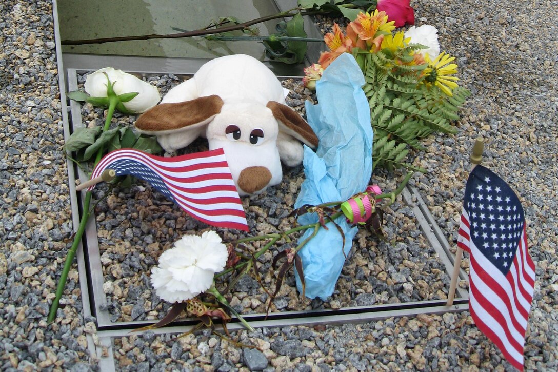 Items left by visitors to the Pentagon Memorial sit near one of the park's 184 inscribed memorial benches, Sept. 12, 2008. Each bench honors a 9/11 terrorist attack victim killed in the building or aboard American Airlines Flight 77. The memorial was dedicated Sept. 11, 2008. DoD photo by John J. Kruzel    