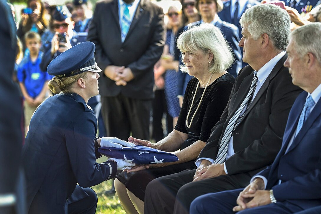 A member of the Air Force honor guard presents the American flag to Terry Harmon, the daughter of  2nd Lt. Elaine Harmon, one of the original Women Airforce Service Pilots, during a ceremony to honor her mother at Arlington National Cemetery, Va., Sept. 7, 2016. Harmon died in 2015 at the age of 95. Air Force photo by Staff Sgt. Alyssa C. Gibson 