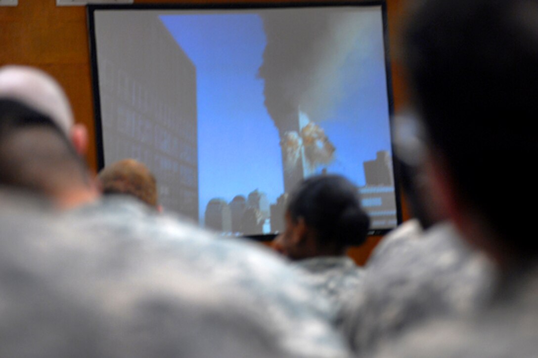 Soldiers watch a slide show during a 9/11 memorial service in the Division Memorial Chapel at Camp Liberty, Iraq, Sept. 11, 2010. The soldiers were assigned to the 1st Armored Division's Division Special Troops Battalion. Army photo by Cpl. Daniel Eddy