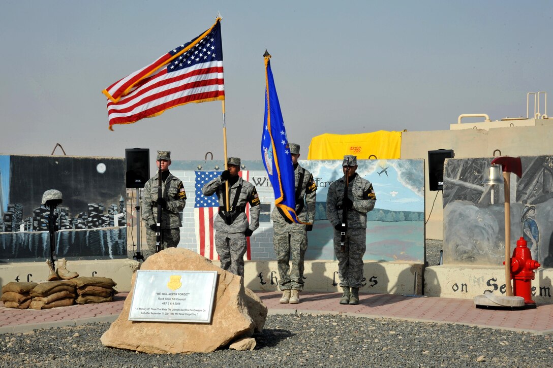 An Air Force honor guard carries in the U.S. and Air Force flags during a 9/11 memorial ceremony at Ali Al Salem Air Base, Kuwait, Sept. 11, 2011. The airmen were assigned to the 386th Air Expeditionary Wing. Air Force photo by Master Sgt. Carlotta Holley