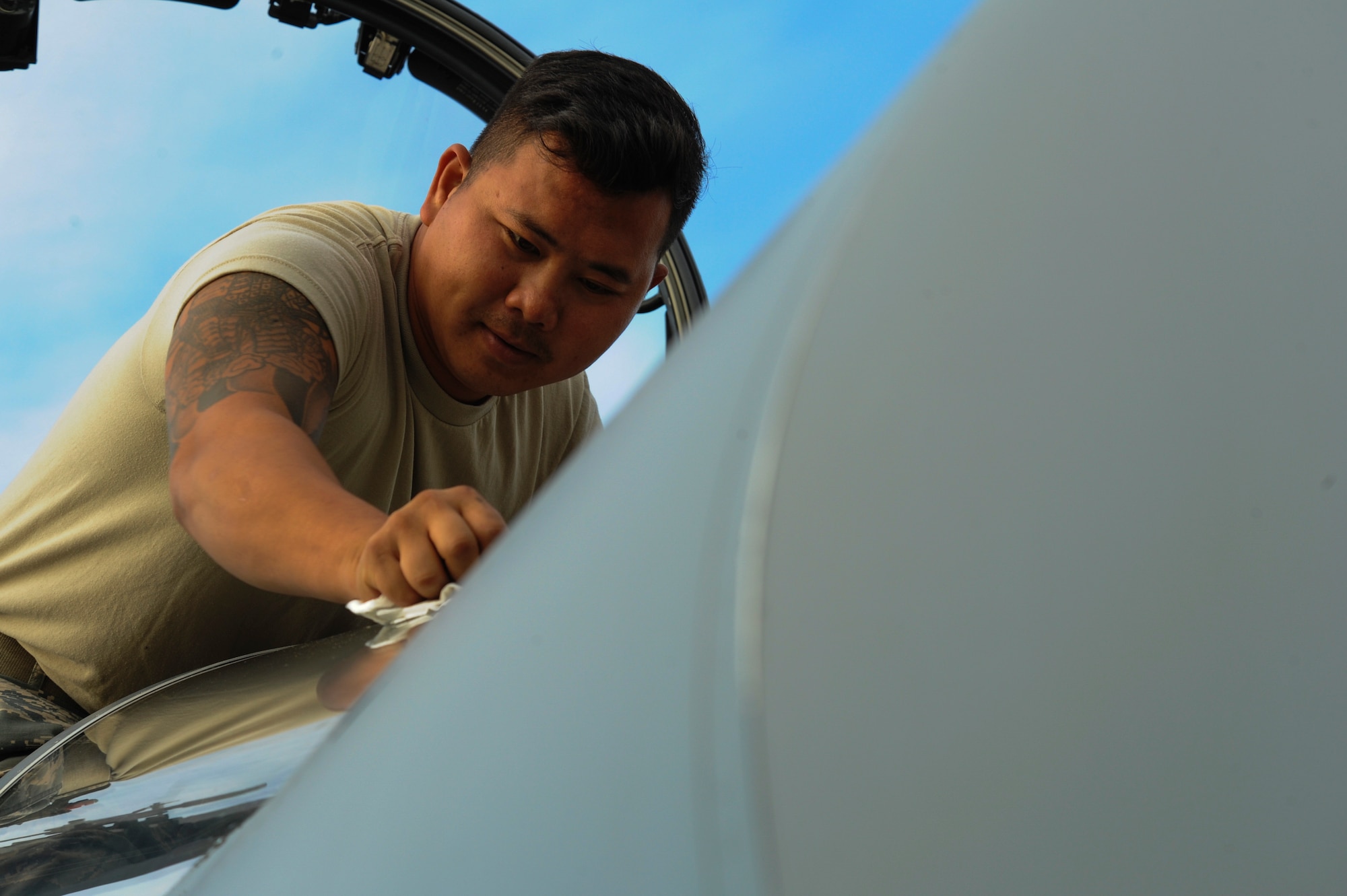California Air National Guard Staff Sgt. Tee Xiong, a 194th Expeditionary Fighter Squadron crew chief, cleans the windshield of an F-15C Eagle fighter aircraft on the flightline at Graf Ignatievo, Bulgaria, Sept. 8, 2016. Four of the squadron’s F-15Cs will conduct joint NATO air policing missions with the Bulgarian air force to police the host nation’s sovereign airspace Sept. 9-16, 2016. The squadron forward deployed to Graf Ignatievo from Campia Turzii, Romania, where they serve on a theater security package deployment to Europe as a part of Operation Atlantic Resolve. (U.S. Air Force photo by Staff Sgt. Joe W. McFadden) 