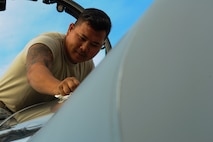California Air National Guard Staff Sgt. Tee Xiong, a 194th Expeditionary Fighter Squadron crew chief, cleans the windshield of an F-15C Eagle fighter aircraft on the flightline at Graf Ignatievo, Bulgaria, Sept. 8, 2016. Four of the squadron’s F-15Cs will conduct joint NATO air policing missions with the Bulgarian air force to police the host nation’s sovereign airspace Sept. 9-16, 2016. The squadron forward deployed to Graf Ignatievo from Campia Turzii, Romania, where they serve on a theater security package deployment to Europe as a part of Operation Atlantic Resolve. (U.S. Air Force photo by Staff Sgt. Joe W. McFadden) 