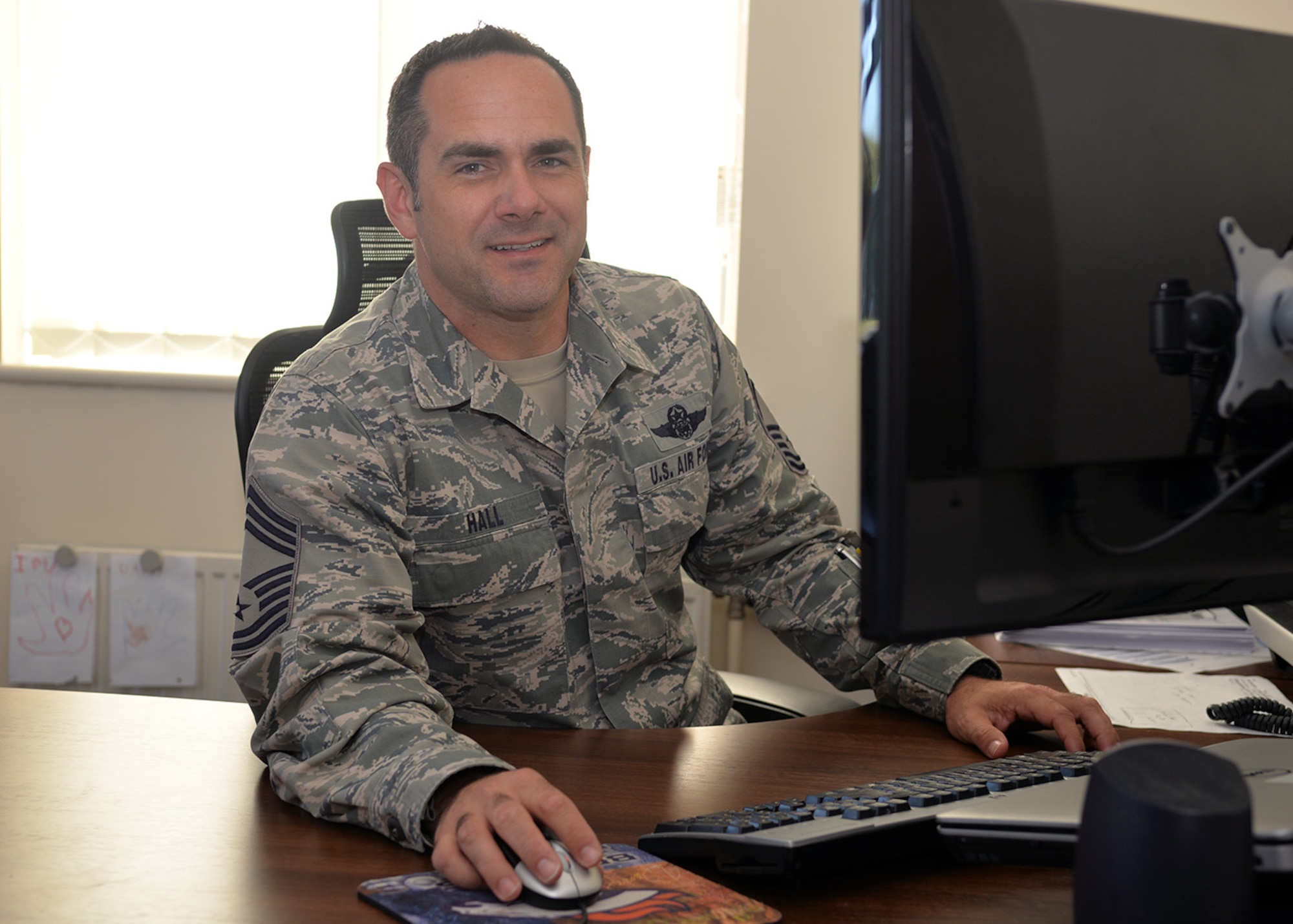 U.S. Air Force Chief Master Sgt. Dustin Hall, 352nd Special Operations Support Squadron chief enlisted manager, poses for a photo Sept. 8, 2016, on RAF Mildenhall, England. In September 2001, Hall was a staff sergeant in the 1st Airborne Communication and Control Squadron, based at Offutt Air Force Base, Neb. He was working as an airborne secure voice operator on an E4-B Advanced Aircraft Command Post aircraft when the news broke of the Sept. 11 attacks in New York. (U.S. Air Force photo by Karen Abeyasekere)