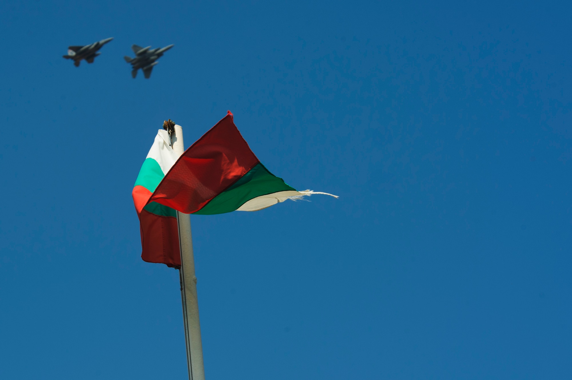 Two California Air National Guard F-15C Eagles fly over a Bulgarian Flag near the flightline at Graf Ignatievo, Bulgaria, Sept. 8, 2016. Four of the 194th Expeditionary Fighter Squadron’s F-15C Eagles will conduct joint NATO air policing missions with the Bulgarian air force to police the host nation’s sovereign airspace Sept. 9-16, 2016. The squadron forward deployed to Graf Ignatievo from Campia Turzii, Romania, where they serve on a theater security package deployment to Europe as a part of Operation Atlantic Resolve. (U.S. Air Force photo by Staff Sgt. Joe W. McFadden) 