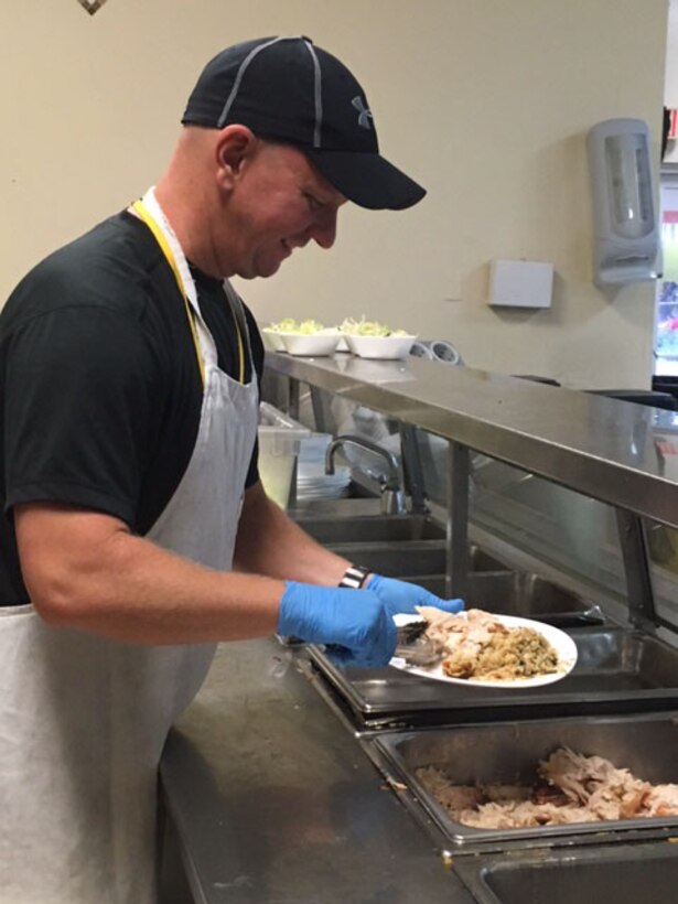 Staff Sgt. Robert Munro, a 482nd Medical Squadron medical technician, prepares a plate of food to be served to a homeless person at the Broward Partnership in Fort Lauderdale, Florida, Sept. 3 2016. (Courtesy photo)