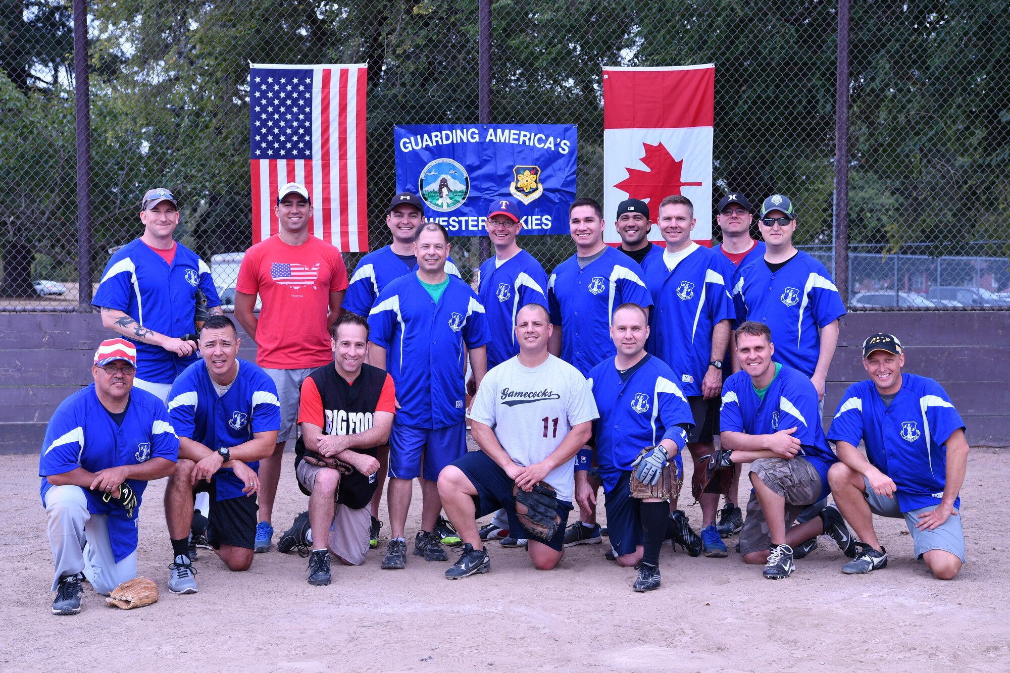 The American's softball team poses for a photo after winning the Western Air Defense Sector U.S. vs Canada Softball Challenge Cup Sept. 1 with a final score of 22 to 7.  Pictured from left to right are: (back row) Keven Blackwell, Nicholas Rhodes, Ian Crocker, Ryc Cyr, Kevin Weaver, David Bauld, Peter Hickam, Ryan McCray, and Michael Delaney.  (Front row) Carlos Gonzales, Allan Lawson, Joseph Landis, Daniel Rebstock, David Quelland, Robert Staszek, Michael Doing, and Jason Weczorek. (U.S. Air National Guard photo by Capt. Kimberly D. Burke)