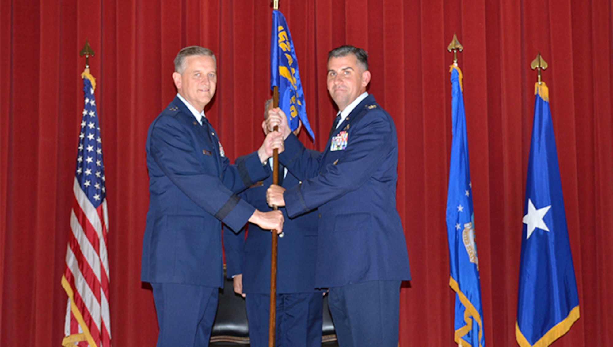 Col. James L. Hartle, right, receives the 452nd Maintenance Group guidon from Brig. Gen. Russell A. Muncy signifying the acceptance for his new role as commander of the 452nd MXG during his Assumption of Command Ceremony, held at the Cultural Resource Center, March Air Reserve Base, Aug. 7. The ceremony is a formal invocation of responsibility, authority, and accountability to the new commander. (U.S. Air Force photo/Senior Airman Joseph Dangidang)

