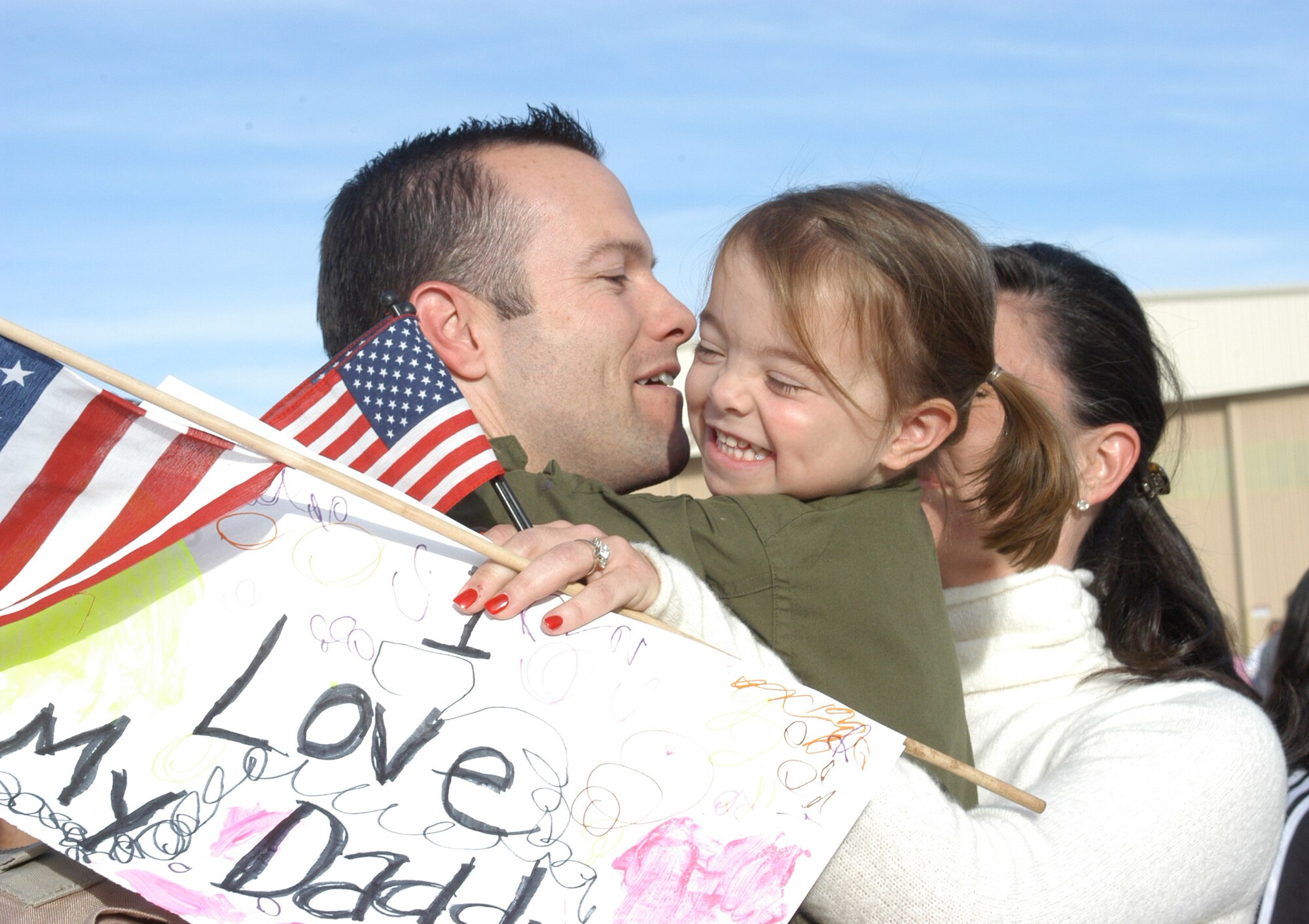 Capt. Chris Gough, 457th Fighter Squadron pilot, gathers hugs of love from his family members after their return from Iraq. More than 150 members of the Air Force Reserve Command's 301st Fighter Wing returned Dec. 11 following a two-month deployment Balad AB, Iraq in support of the Air Expeditionary Forces. Other AFRC F-16 units are scheduled to return from Balad in January. (U.S. Air Force photo by Tech. Sgt. Julie Briden-Garcia)